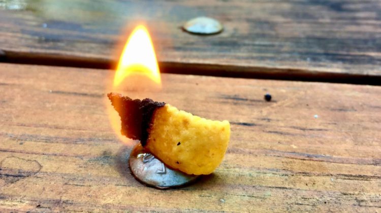 A corn chip burns with a small flame on a picnic table | We’re Willing To Bet You Never Knew These Life Hacks Existed….