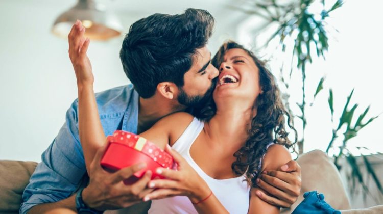 Feature | Man giving a surprise gift to woman at home | Perfect Gifts Ideas For Him and Her For No Occasion At All