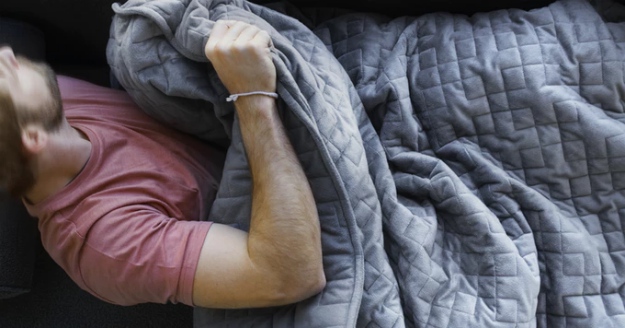 Man sleeping with blanket | A Blanket That Can Relieve Anxiety