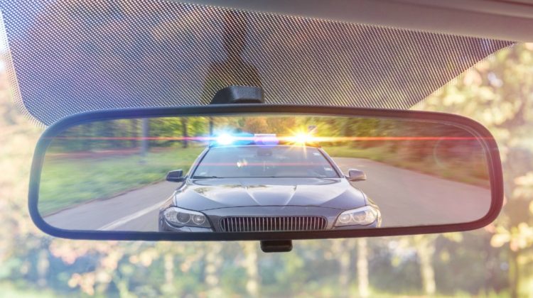 Police car on the rear view mirror | 4 Real Tips From Police To Stay Out Of Trouble﻿